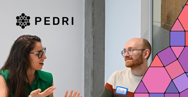 two researchers smiling and talking to eachother, text above reads: Pedri