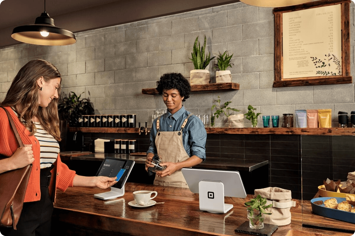 Woman using Square Stand at coffee shop.