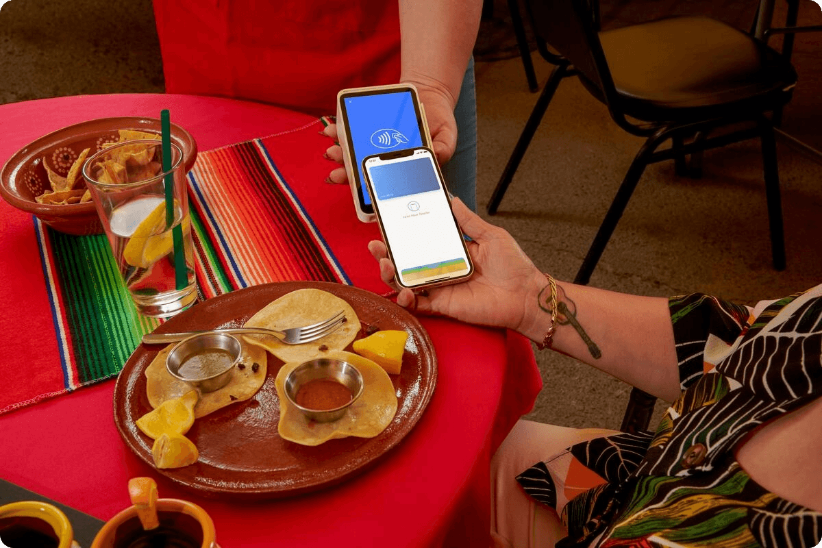 Woman using Square Stand at coffee shop.